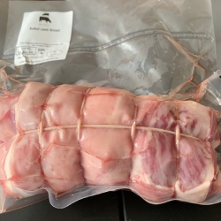 A rolled breast of lamb from Red Down Beef and Lamb on a black background.
